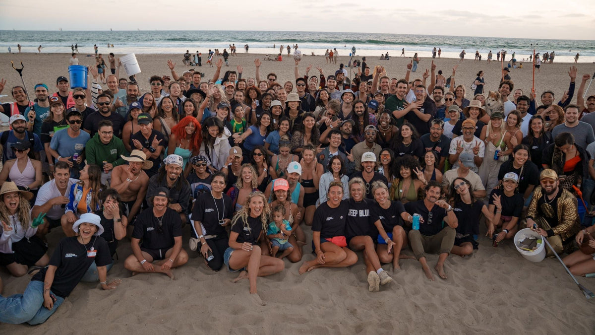 Volunteers gathered for a group photo at sunset after the World's Largest Beach Cleanup at Venice Beach