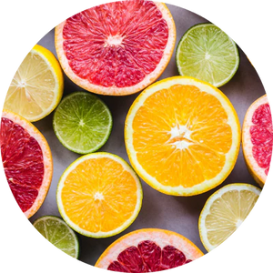 Sliced citrus fruits including oranges, grapefruits, and limes arranged on a surface.
