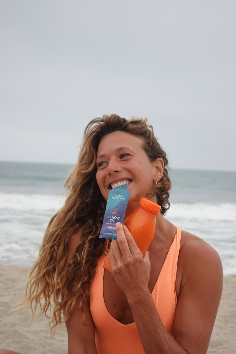 Customer holding a Sea Moss Gel packet against the sky
