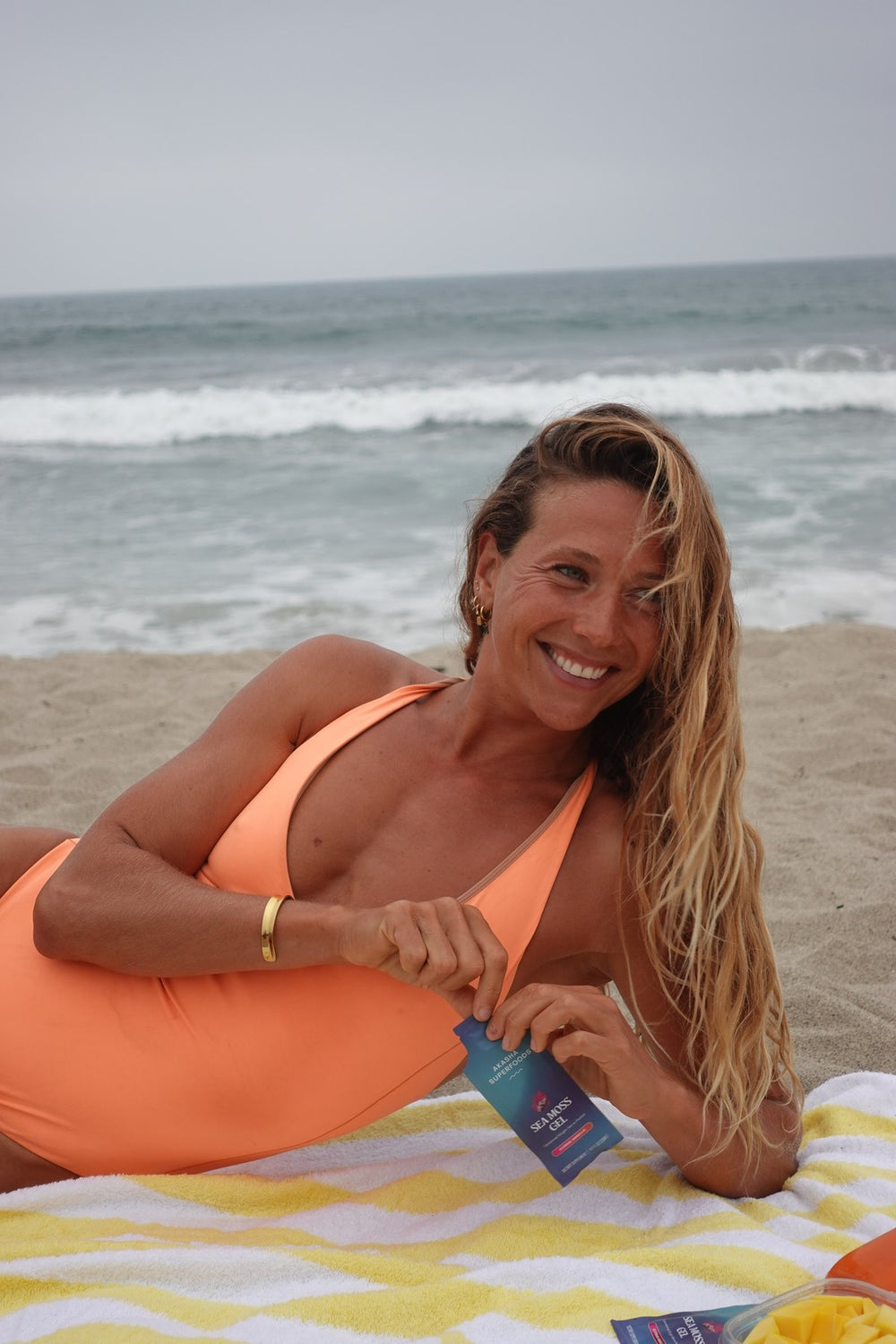 Customer smiling with a Sea Moss Gel packet